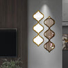 Moroccan-inspired decorative mirror wall stickers featuring gold-edged, ornate mirrors mounted on a gray wall.
