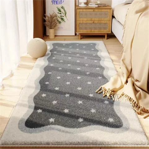 A gray and white patterned area rug placed on a wooden floor in a bright room.