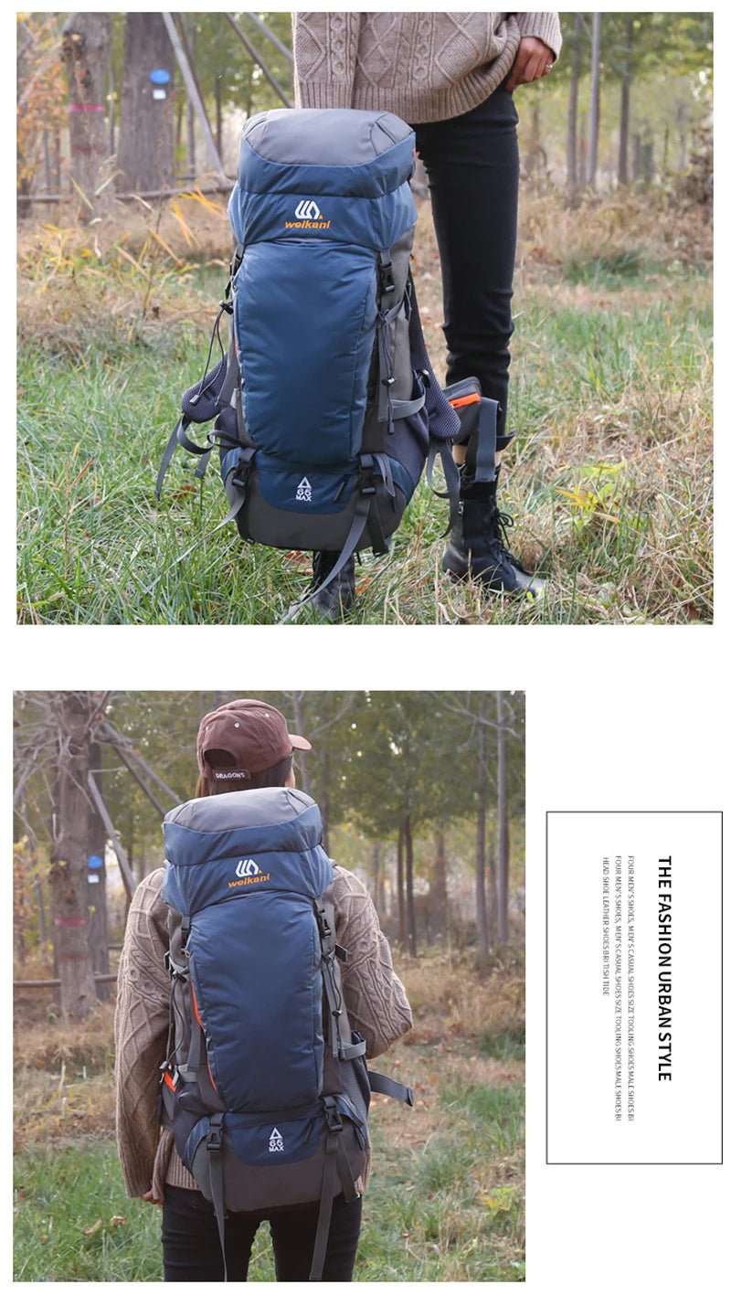 A person is wearing a dark blue waterproof hiking backpack while standing in a grassy outdoor area.