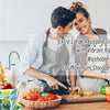 A man and woman in aprons are preparing groceries using extra large reusable bags with vibrant ripstop fabric.