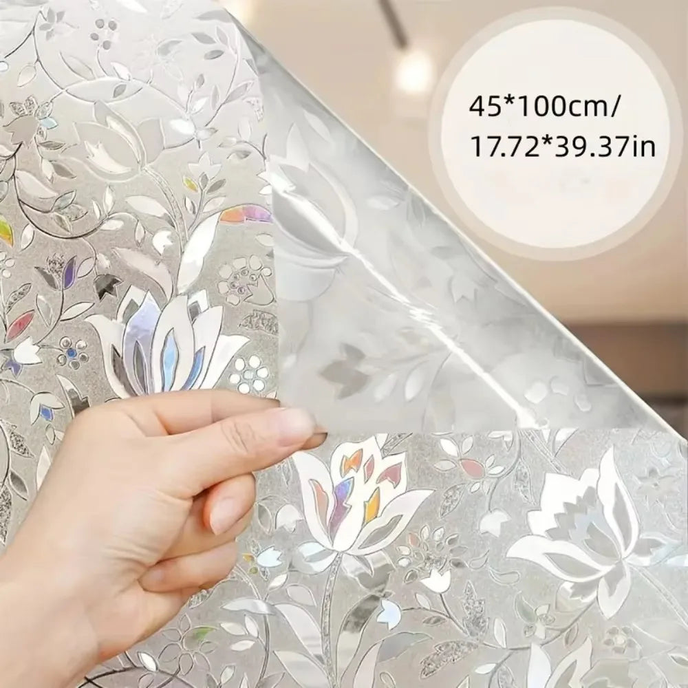 A hand is touching an elegant silver tulip privacy window film, showing its texture and design details.
