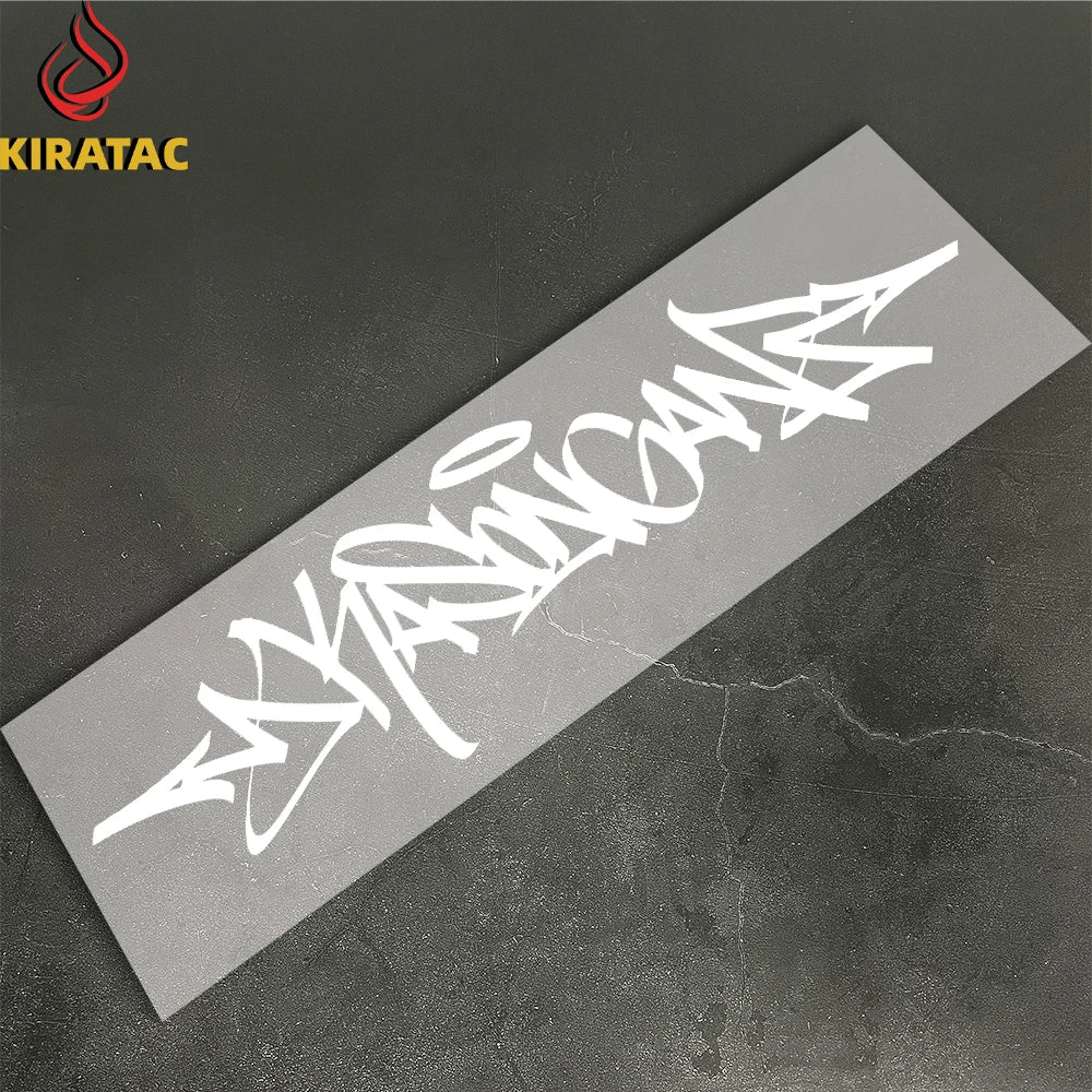 A white wildstyle graffiti decal on a gray surface, likely for a motorcycle helmet.