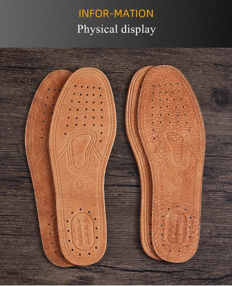 Pair of tan leather insoles displayed on a wooden surface.