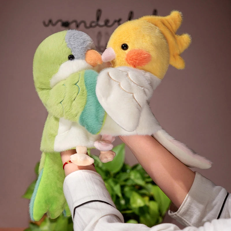 A yellow and green plush parrot hand puppet toy being held by a person.