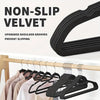 Black velvet non-slip hangers with upgraded shoulder grooves shown hanging on a wooden rod.