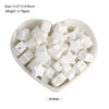 A white silicone crown star heart bead is displayed in a small dish.