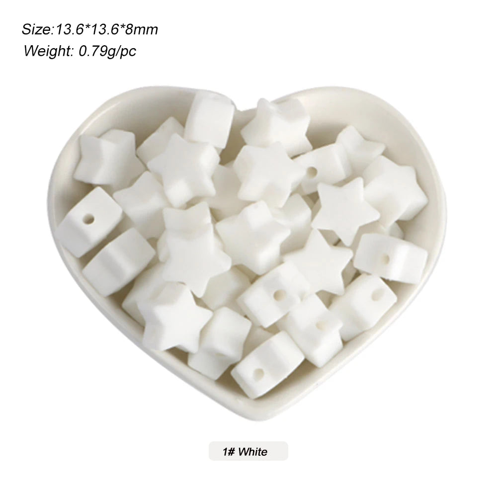 A white silicone crown star heart bead is displayed in a small dish.