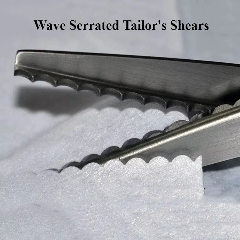 Close-up of a pair of professional stainless steel wave serrated tailor's shears resting on white fabric.