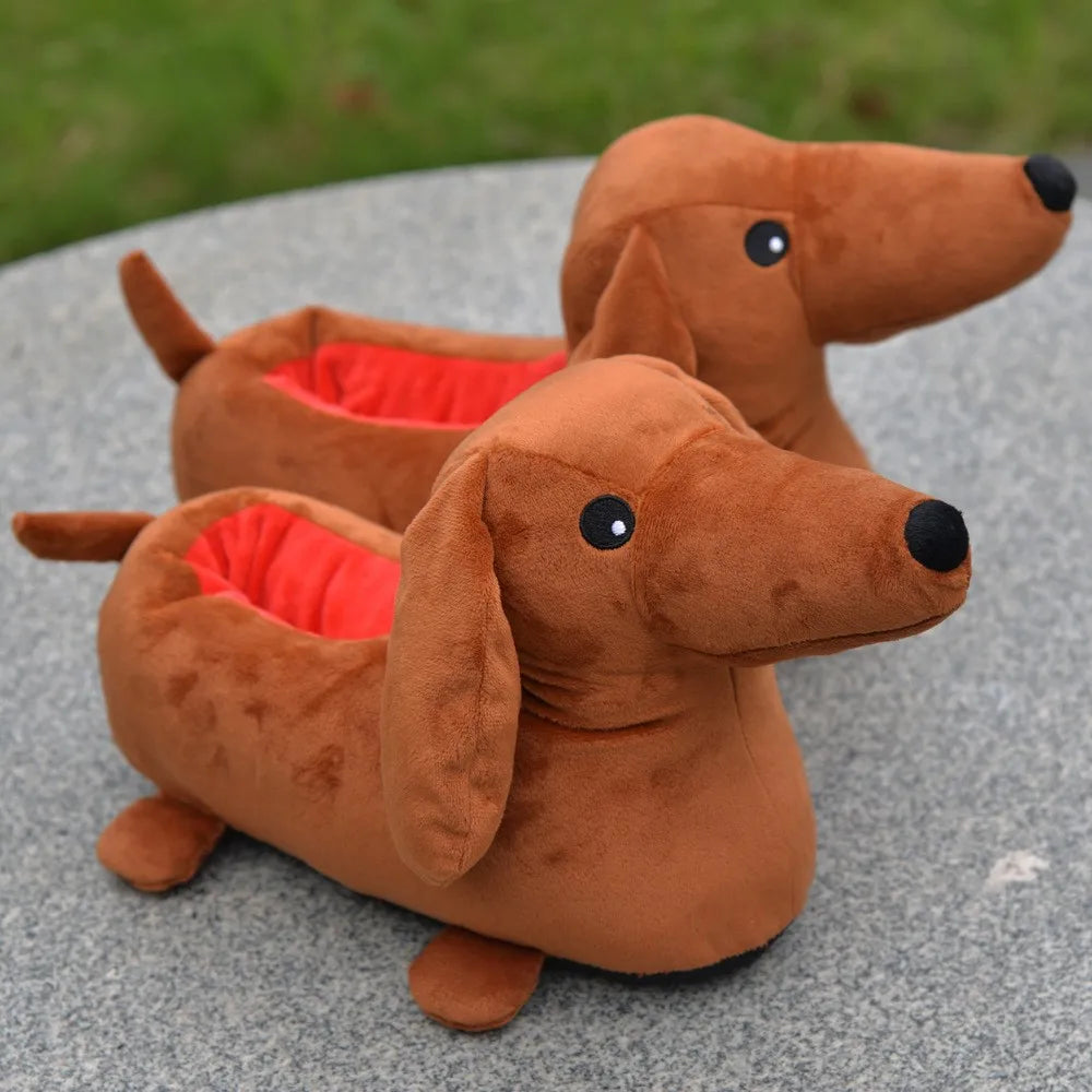 A brown plush toy of a dachshund dog house with red lining, resting on a gray surface.