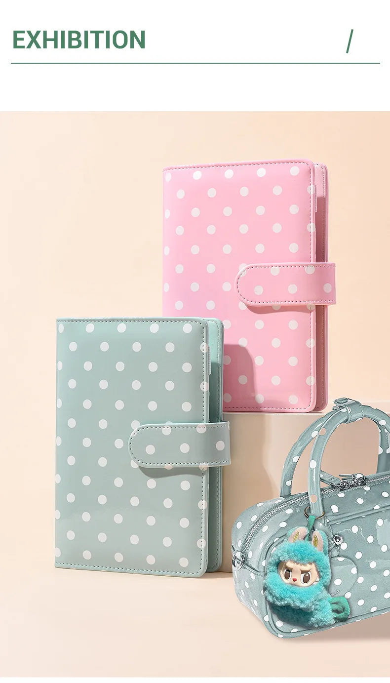 A pink and mint green polka dot PU leather binder wallet with cash envelopes and card holder displayed on a light background.