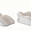 A light beige ergonomic memory foam wedge pillow with a detachable head rest shown from the side.