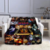 A black and gold printed flannel throw blanket featuring various Kiss band imagery.