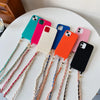 A collection of colorful phone cases attached to universal chain straps, displayed on a white surface.