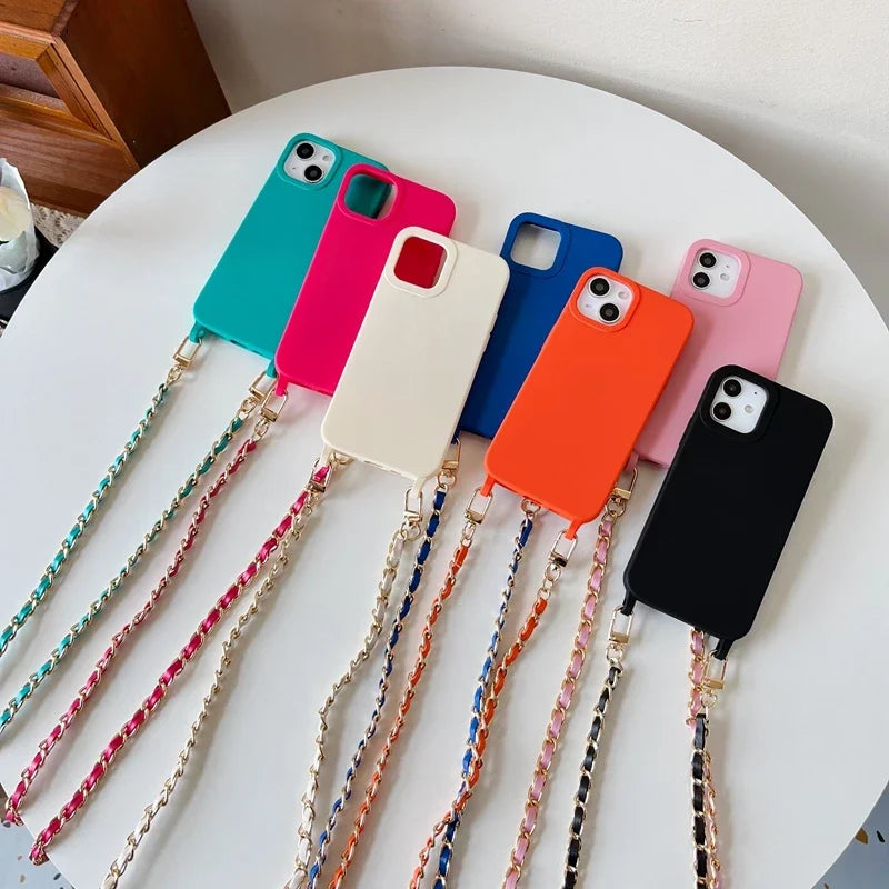 A collection of colorful phone cases attached to universal chain straps, displayed on a white surface.
