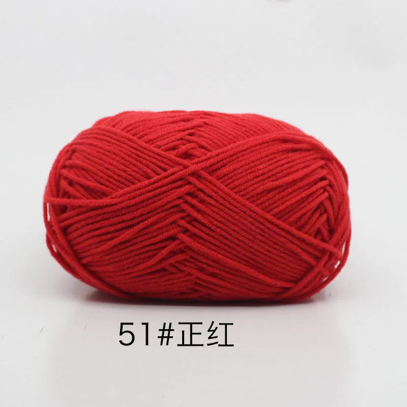 A ball of bright red 4-ply milk cotton yarn for knitting and crochet.