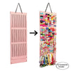 A pink hair bow and clip organizer with a rope hanger, featuring multiple sections of colorful fabric.