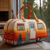 An orange and white quilted travel duffle bag with wooden handles sits on a light surface.