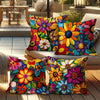 A set of colorful floral print decorative pillows displayed on a light-colored sofa.