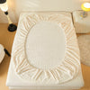 A beige cozy faux fur fitted sheet displayed on a white mattress.