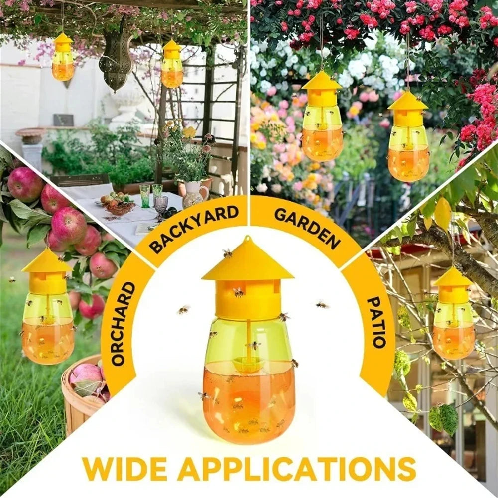 A collection of yellow glass fruit fly traps with pheromone lures hanging in a garden setting.