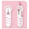 A white retractable cat paw utility knife with pink accents shown against a pink background.