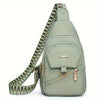 A light green PU leather crossbody bag with a patterned strap and gold hardware.
