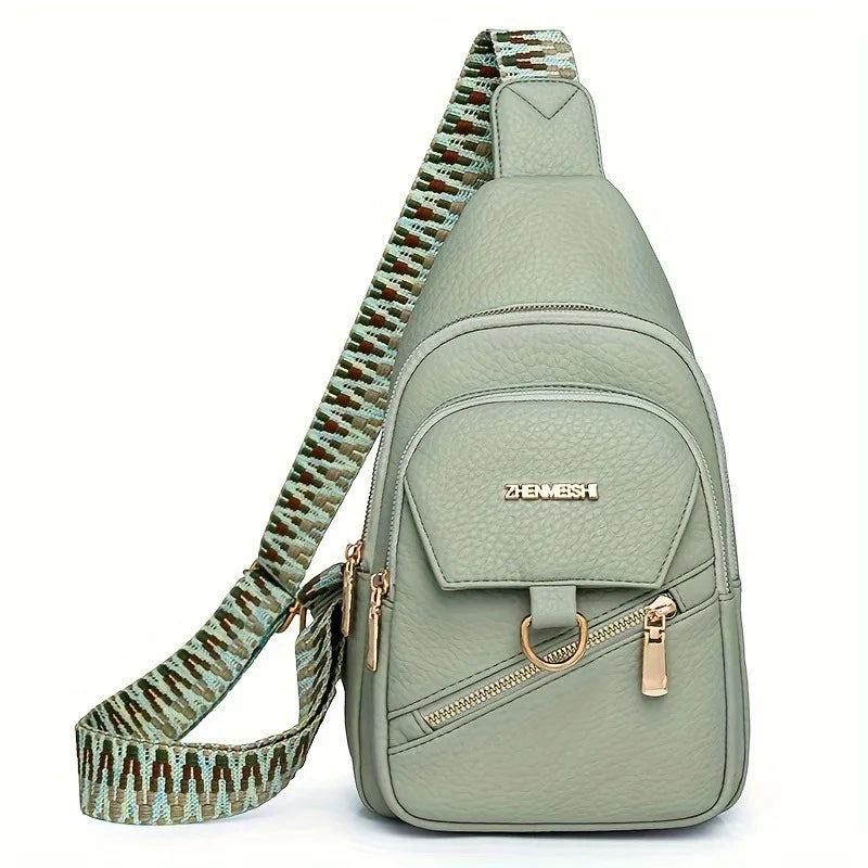 A light green PU leather crossbody bag with a patterned strap and gold hardware.