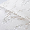 Roll of white embossed damask wallpaper featuring delicate floral scrollwork design.