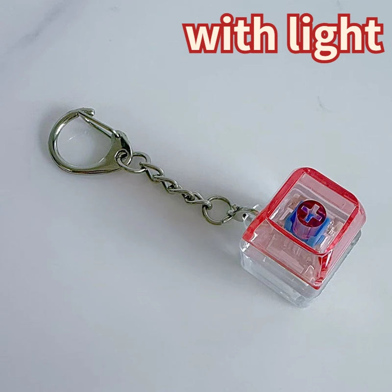 A silver chain keychain featuring a red and clear plastic component with a blue LED light inside.