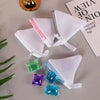 A collection of three reusable white mesh laundry bags filled with colorful liquid soap or detergent.