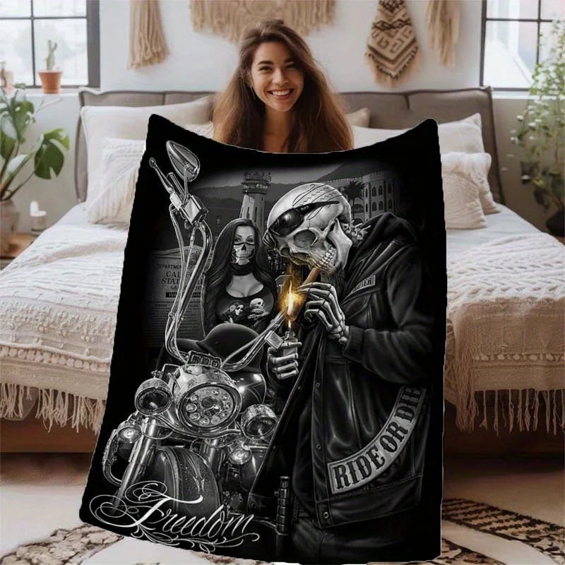 A black print featuring a vintage skull and biker theme on a throw blanket.