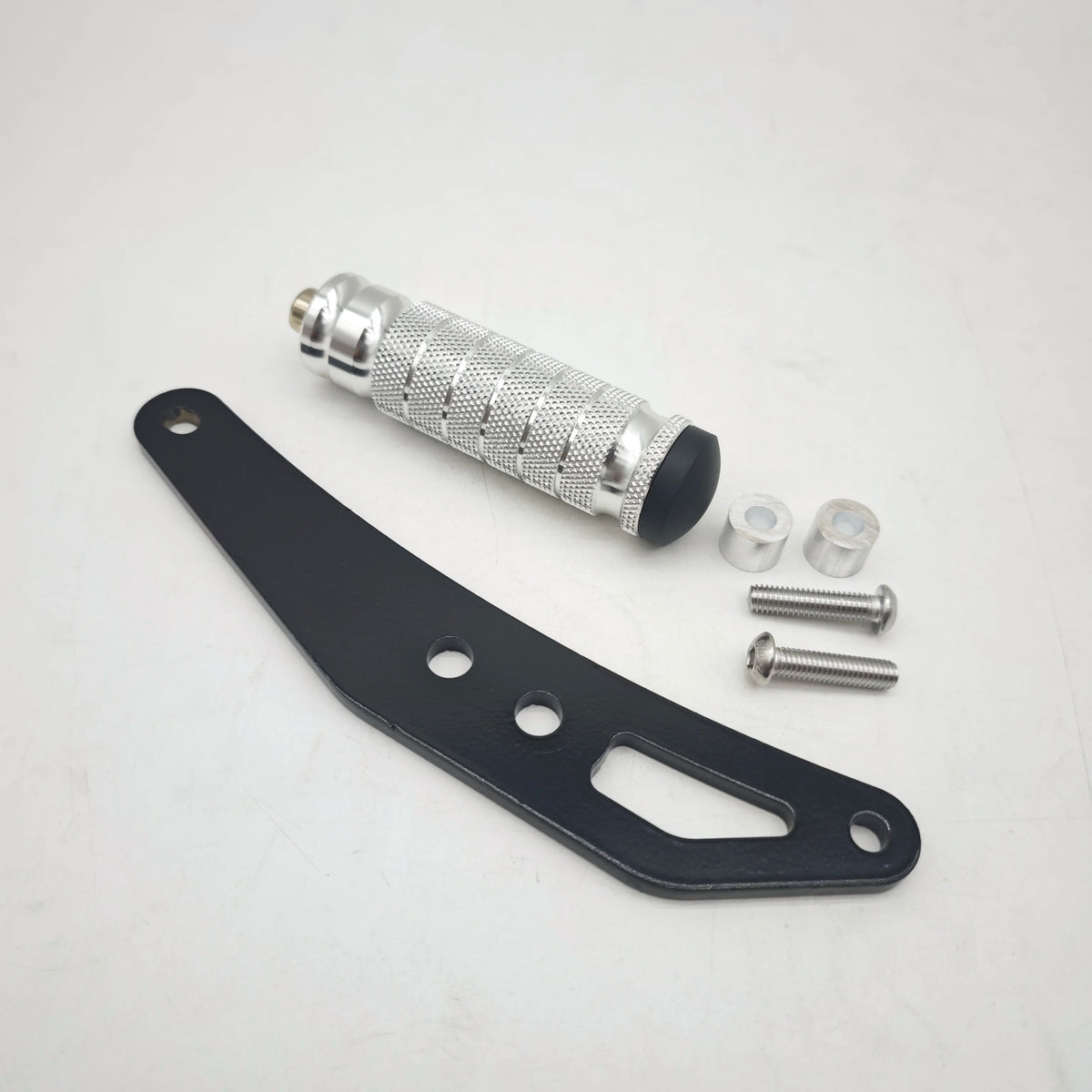 A set of CNC aluminum foot pegs and mounting hardware for electric dirt bikes.