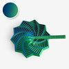 A green 3D illusion fidget star with a swirling spiral design and a small circular color swatch.
