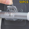A hand is installing clear self-adhesive curtain rod hooks onto a gray metal rod, with a sheet of adhesive backing visible.