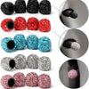 A collection of crystal-cut tire valve caps in various colors including black, red, and blue glitter finishes.