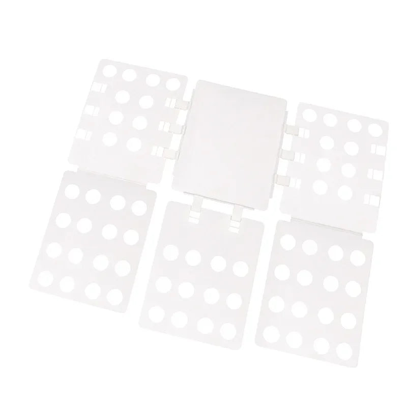 A white magic clothes folding board with multiple compartments for organizing t-shirts.