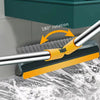 A close-up of a yellow and black rotating floor scrub brush with a long silver handle, demonstrating a 180 degree rotation.
