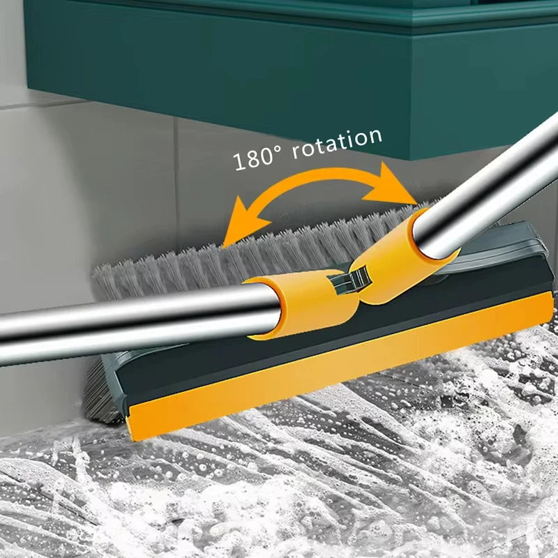 A close-up of a yellow and black rotating floor scrub brush with a long silver handle, demonstrating a 180 degree rotation.