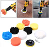 A set of various colored polishing pads and tools for car detailing, including foam pads and a polishing attachment.