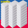 A stack of white melamine sponge cleaning erasers is shown on a red surface.