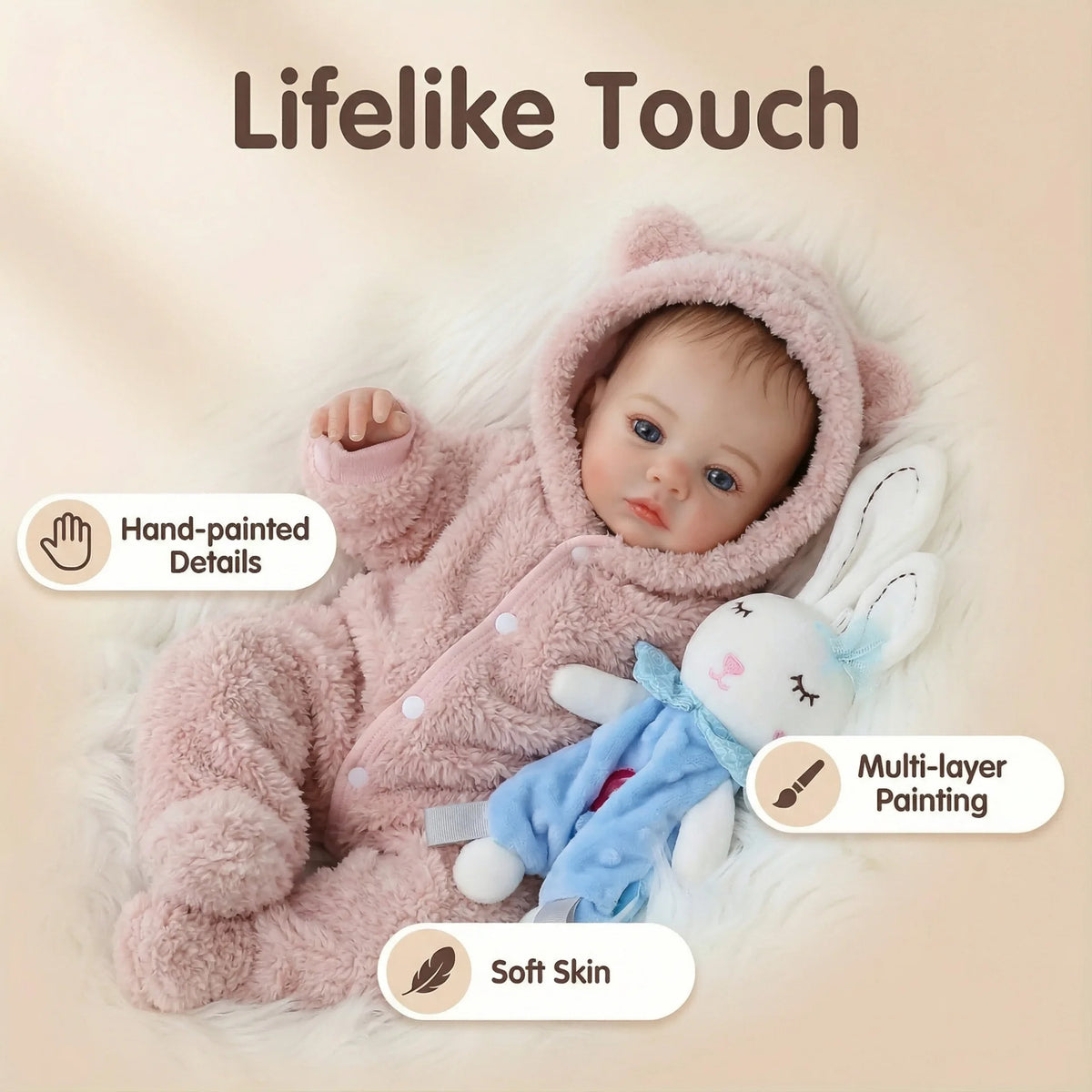 A lifelike reborn baby doll with a pink fluffy outfit and soft skin texture.