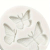 White silicone molds shaped like butterflies for crafting candles, clay, and resin