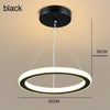 A black modern LED ceiling light with a circular ring design is shown hanging from the ceiling.