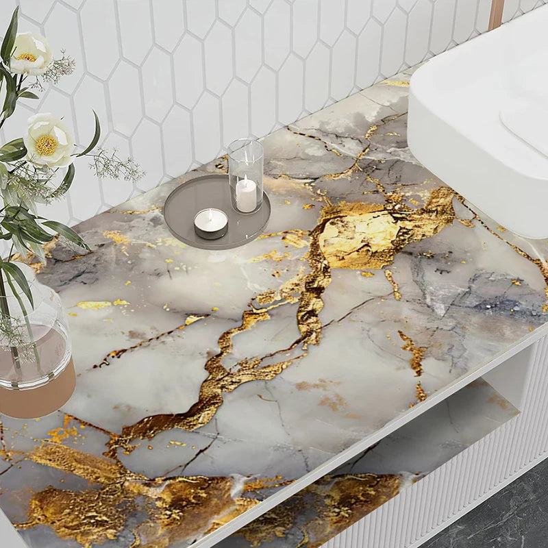 A marble peel-and-stick backsplash featuring gold veins on a white and gray background.