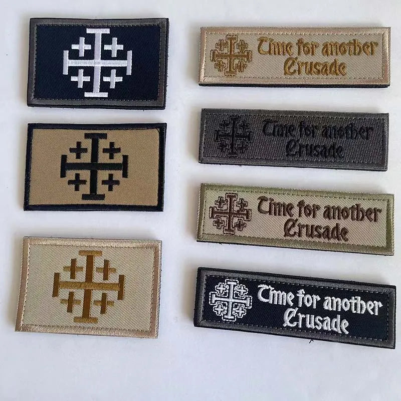 A collection of five embroidered tactical patches featuring the Knights Templar cross design and text related to a Crusade.