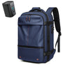 A navy blue expandable travel laptop backpack with black accents and a separate vacuum compression device.