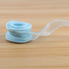 A roll of light blue satin ribbon, 10 yards long and 40mm wide, unwound on a wooden surface.