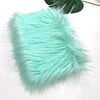 A fluffy teal faux fur fabric used for DIY sewing, doll hair, and cosplay.