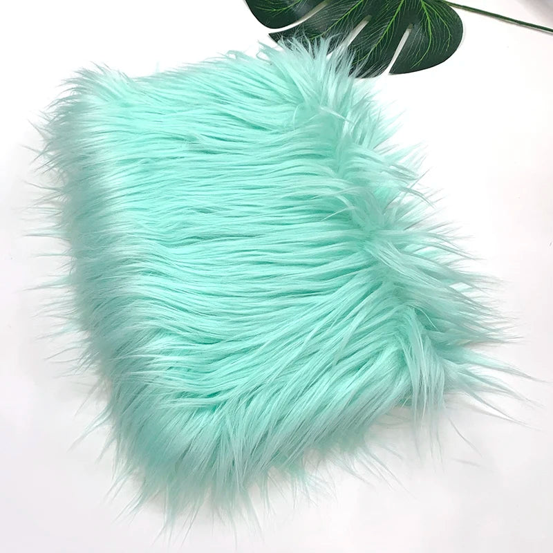 A fluffy teal faux fur fabric used for DIY sewing, doll hair, and cosplay.