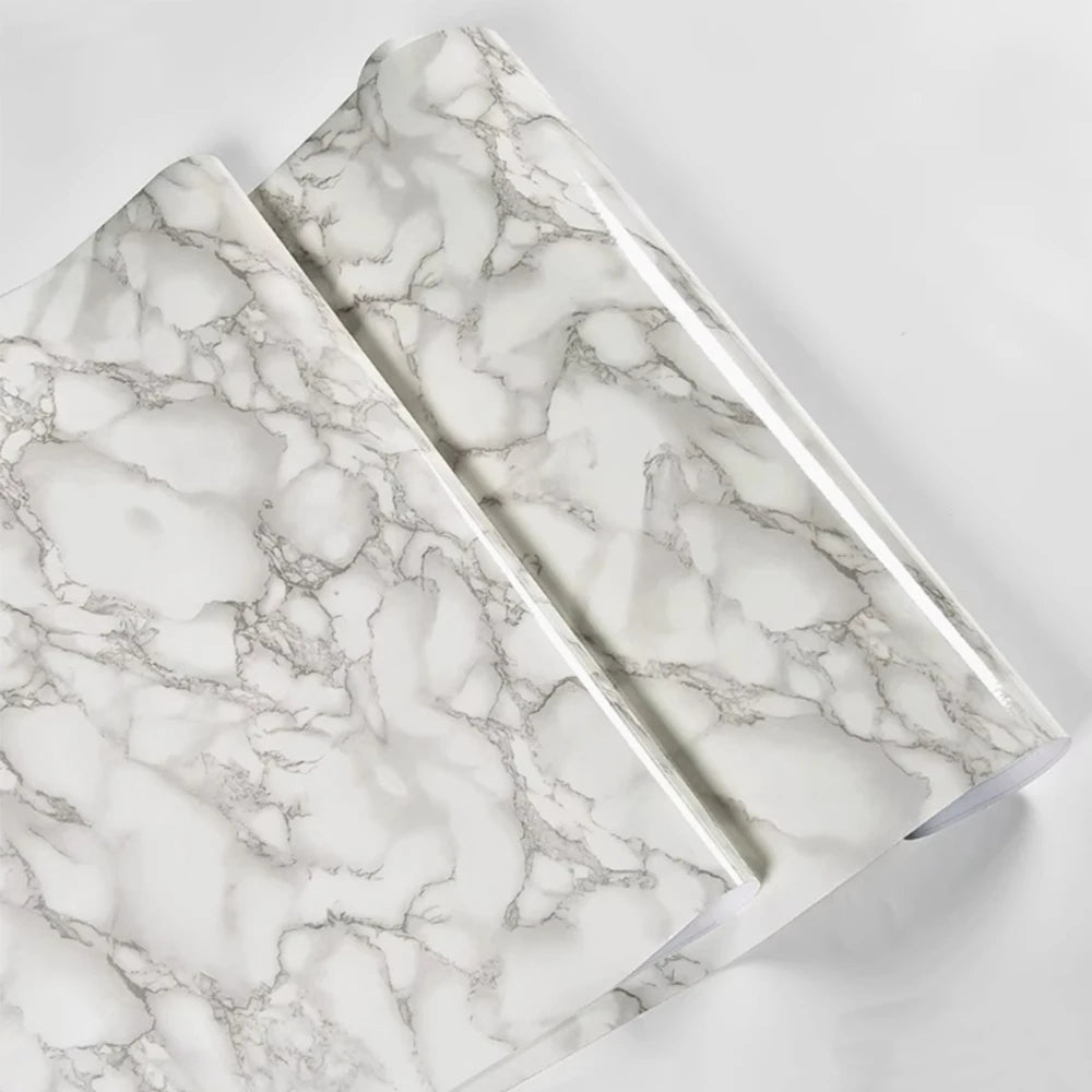 A close-up view of marble peel-and-stick wallpaper featuring white and gray veining.